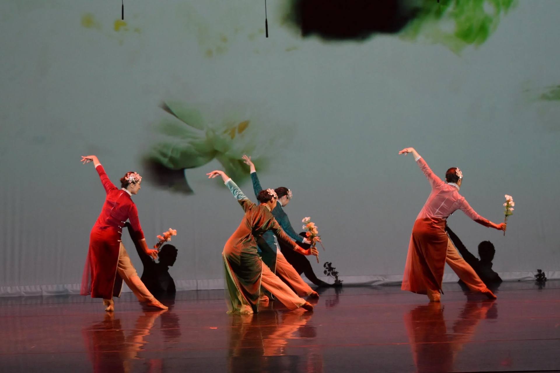 YiYe dancers in qipao performing a Chinese classical piece on stage, flowers in hand